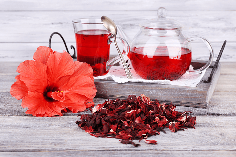 hibiscus tea in glass cup and teapot