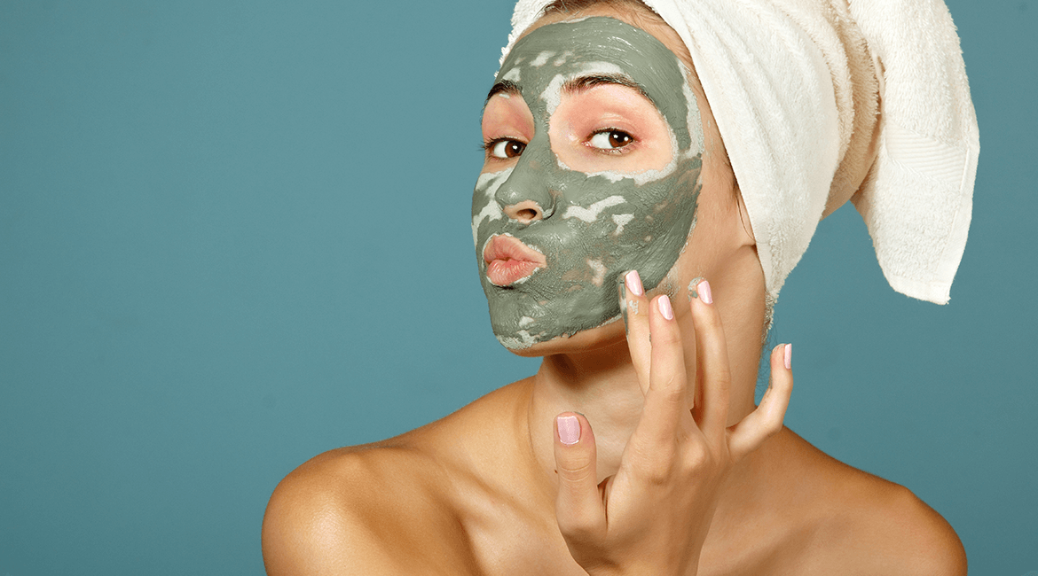 Woman looking confused with green face mask.